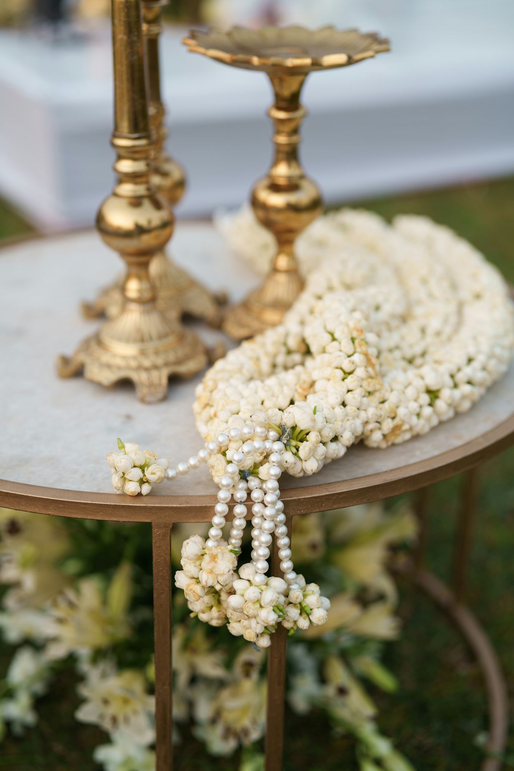 Ivory Bloom invitation cover with a jasmine garland, reading You're invited, Bhumi and Abhishek, Tap to open